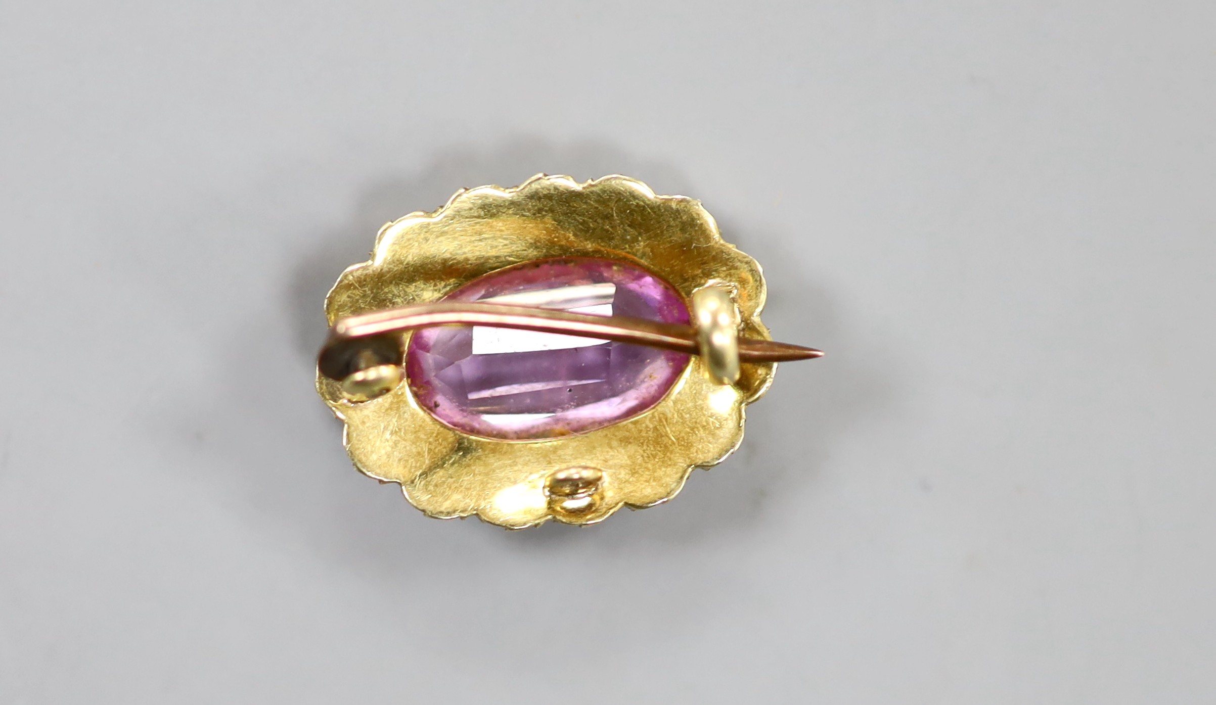 A yellow metal synthetic? pink sapphire and split pearl set oval brooch, 17mm, gross weight 2.4 grams.